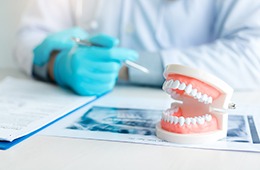 A closeup of dentures on a table where a dentist is working
