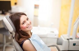 A woman smiling at her dental appointment.