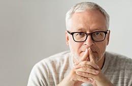 Man thinking about the cost of his dental emergency