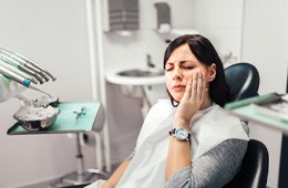 Female patient with toothache visiting emergency dentist in Campbell
