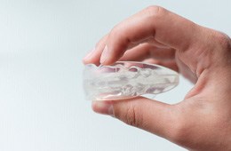 Close up of hand holding a nightguard