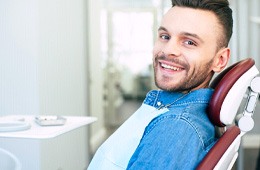 Man sitting back in dental chair smiling