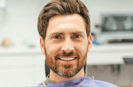Close up of man in dental chair smiling