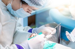 a dentist performing a treatment on a patient