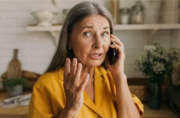 a concerned woman on the phone