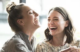 Two women laughing together