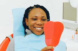 Female dental patient looking in a mirror