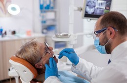 Implant dentist in Campbell performing a dental exam