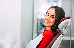 Woman with dental implants in Campbell, CA at dentist’s office