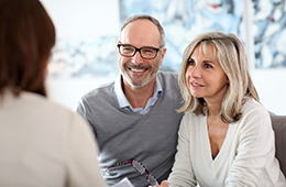 man and woman at dental implant consultation 