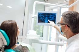 dentist showing a patient their X-rays