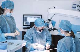 dentists performing dental implant surgery
