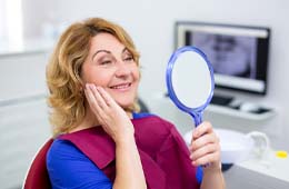 patient admiring her new smile