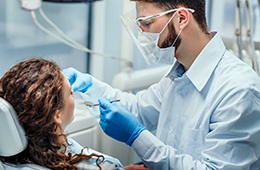 Dentist conducting dental exam on patient